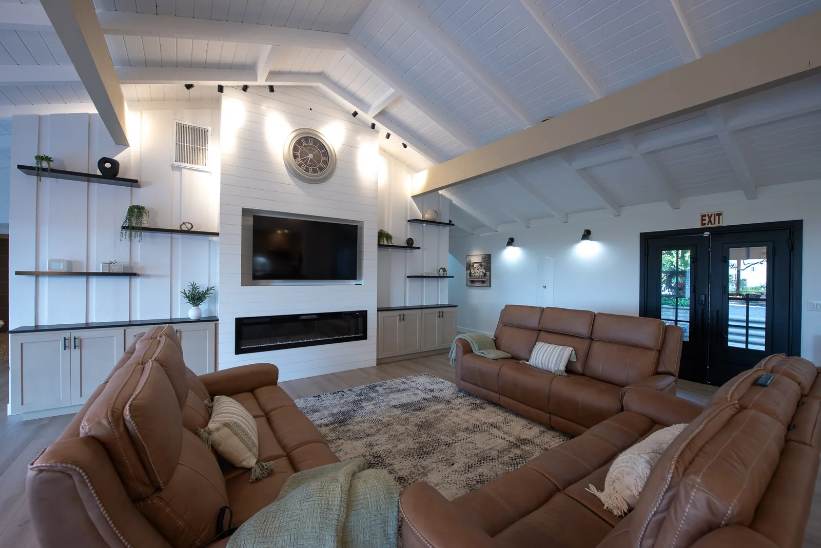 Living room with vaulted wood-beam ceiling and comfortable seating at Ohana Excellence Crown Ranch, Corona, California