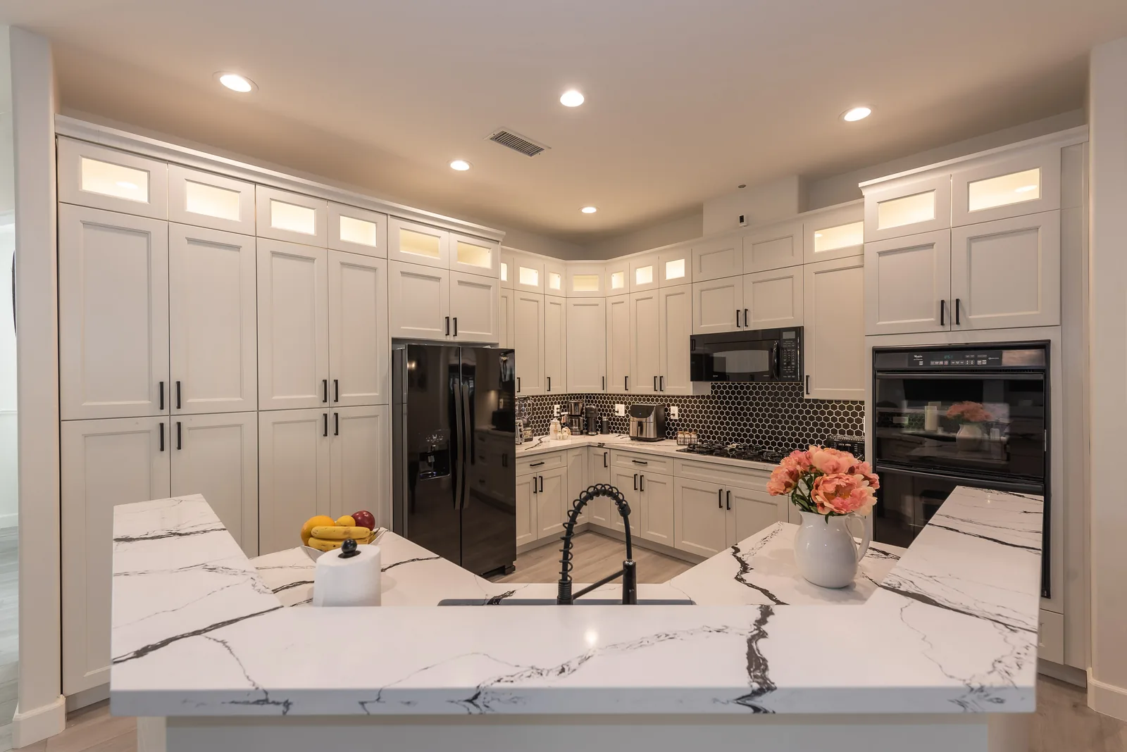 Kitchen with center island and warm lighting where meals are prepared at Manitou Home